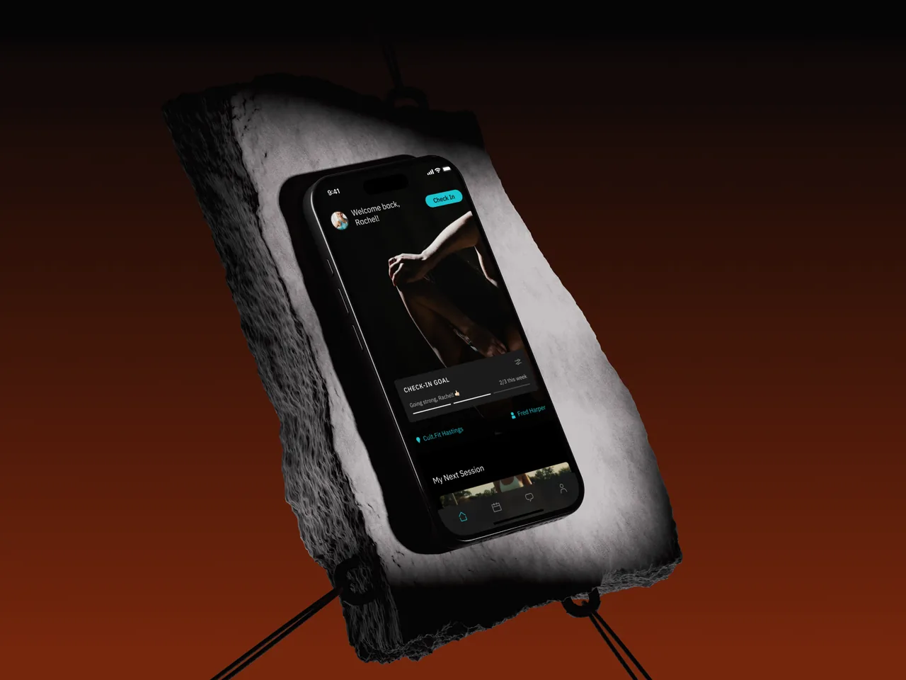TRAIN ON membership app home screen, on a phone mounted to a dark slab